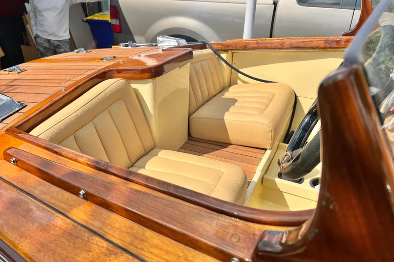 Slide: The Image of Luxurious Custom Line 17 boat interior, 2025 model, featuring elegant wood and beige leather seating. - 43