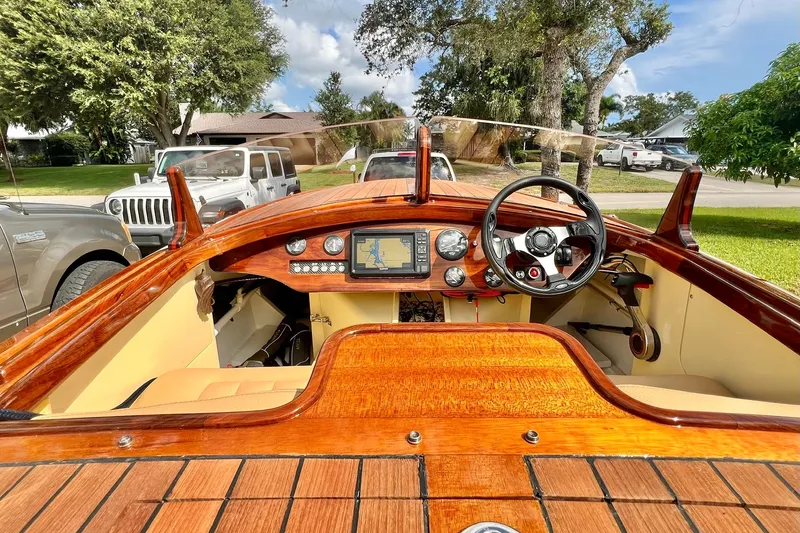Slide: The Image of Interior view of a 2025 Custom Line 17 boat with wooden dashboard and modern controls. - 39