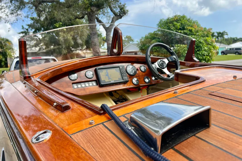Slide: The Image of Wooden dashboard of a 2025 Custom Line 17 boat with steering wheel and navigation system. - 29