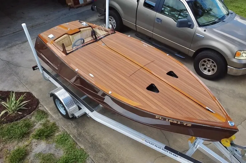 Slide: The Image of Custom Line 17 boat on trailer, 2025 model, featuring sleek wooden design. - 3