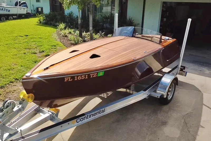 The Image of Custom Line 17 boat, 2025 model, on a trailer in a driveway. - 0
