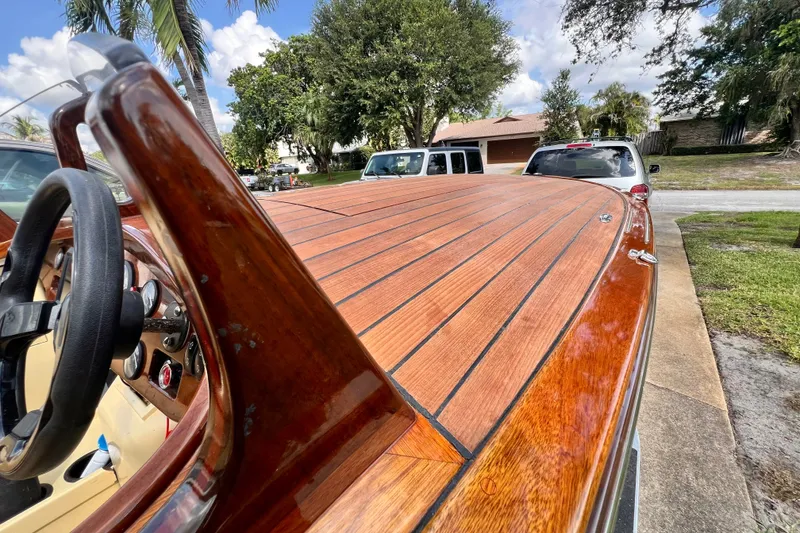 Slide: The Image of Custom Line 17 boat, 2025 model, featuring polished wooden deck and steering wheel. - 45