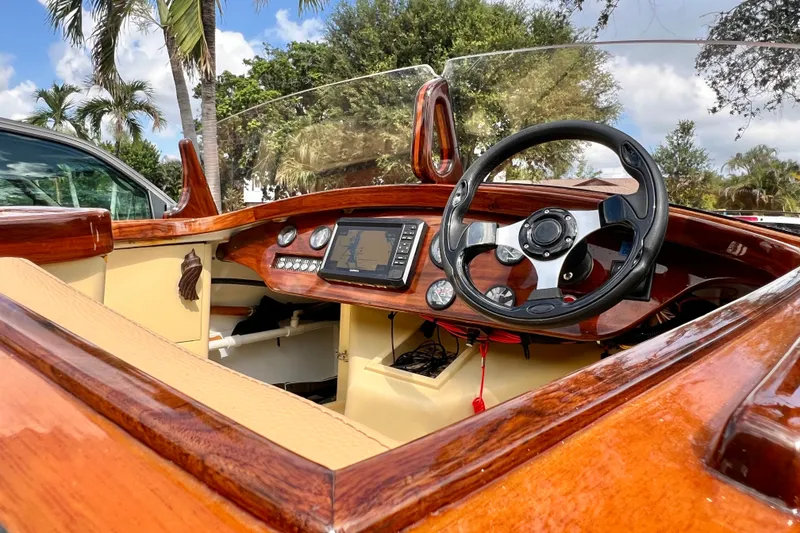 Slide: The Image of Interior of a 2025 Custom Line 17 boat with wooden dashboard and modern steering. - 41