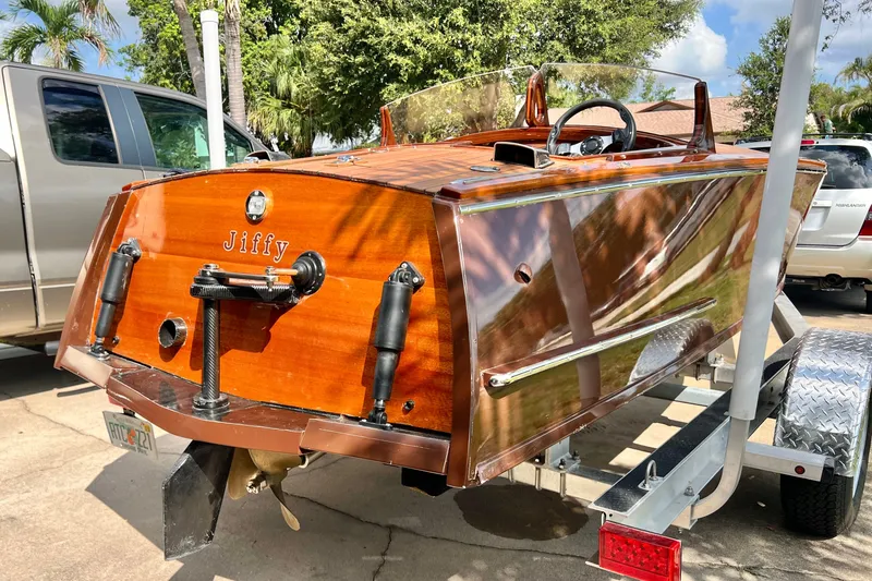 Slide: The Image of Custom Line 17 boat, 2025 model, with polished wood finish on a trailer. - 34
