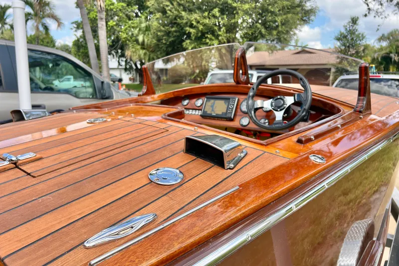 Slide: The Image of Luxurious 2025 Custom Line 17 boat with polished wood finish and modern dashboard. - 40