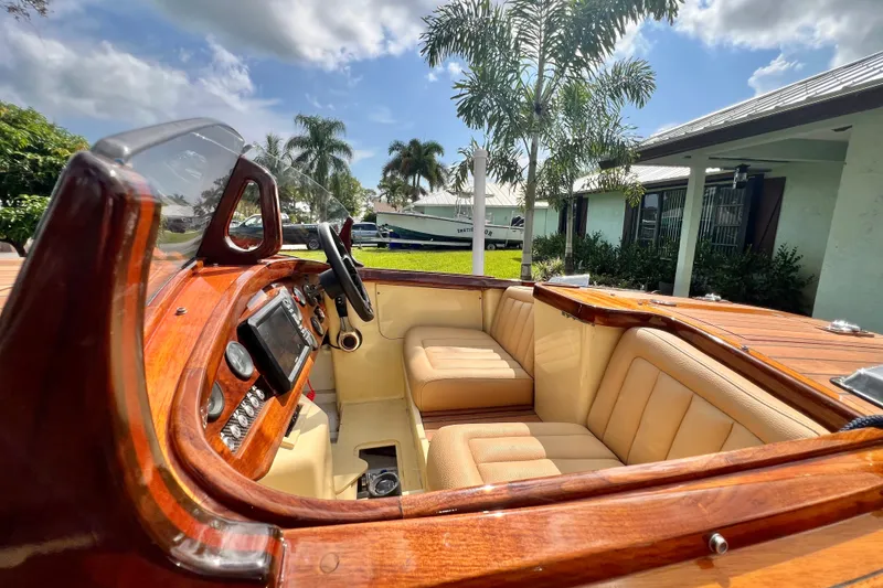 Slide: The Image of Luxurious 2025 Custom Line 17 boat interior with wooden dashboard and beige seating. - 31