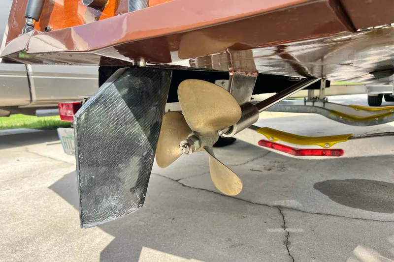 Slide: The Image of Close-up of a 2025 Custom Line 17 boat propeller and rudder on a trailer. - 37