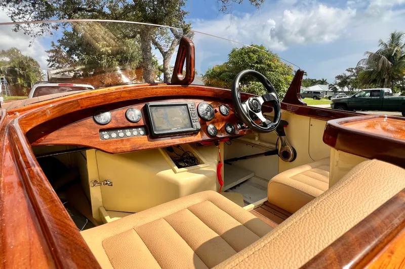 Slide: The Image of Luxurious 2025 Custom Line 17 boat interior with wooden dashboard and modern controls. - 30