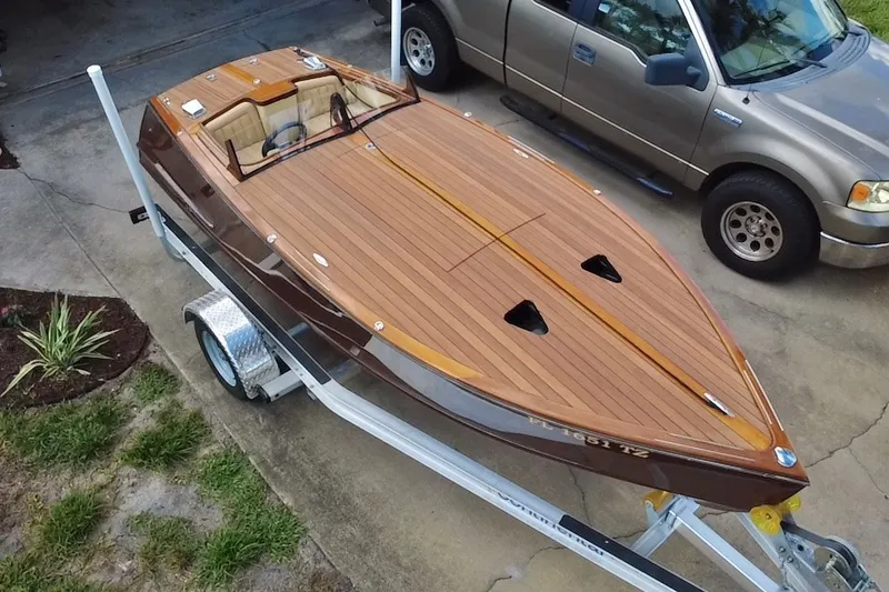 Slide: The Image of Custom Line 17 boat, 2025 model, with sleek wooden deck on a trailer. - 4