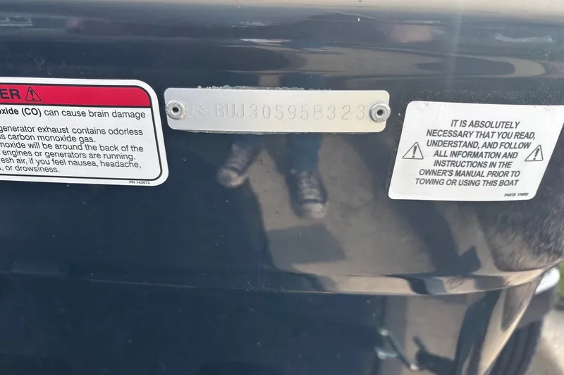 Slide: The Image of 2024 Tahoe T16 boat with warning labels and identification plate. - 8
