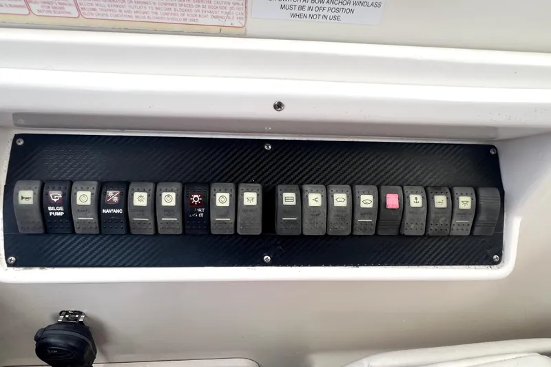 Slide: The Image of Control panel of a 2006 Regal Commodore 3560 IB boat with labeled switches. - 42