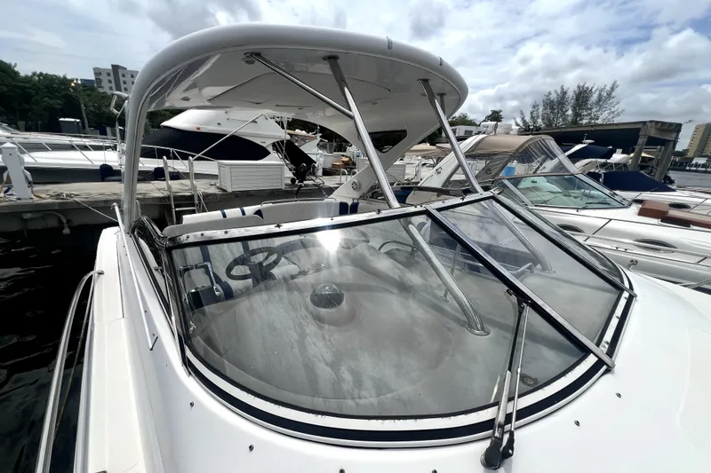 Slide: The Image of 2006 Regal Commodore 3560 IB yacht docked at marina under cloudy sky. - 57