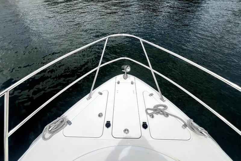 Slide: The Image of Bow view of 2006 Regal Commodore 3560 IB yacht on calm water. - 23