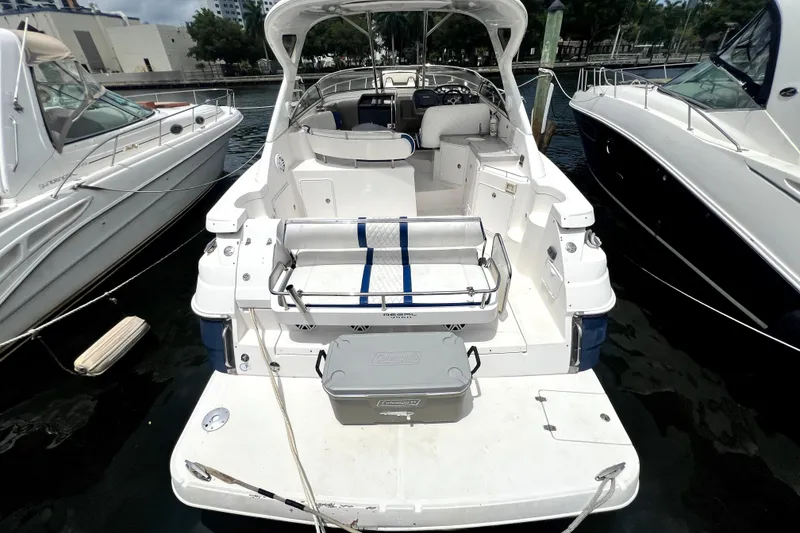 Slide: The Image of 2006 Regal Commodore 3560 IB yacht docked, showcasing spacious deck and seating area. - 38