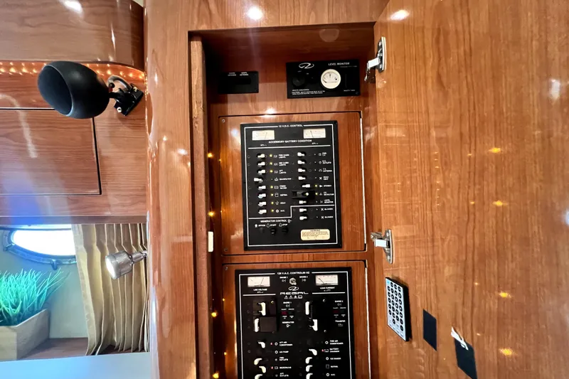 Slide: The Image of Electrical control panel inside a 2006 Regal Commodore 3560 IB yacht cabin. - 75