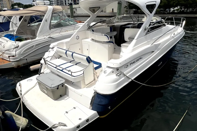 Slide: The Image of 2006 Regal Commodore 3560 IB yacht docked in marina, featuring sleek design and spacious deck. - 39