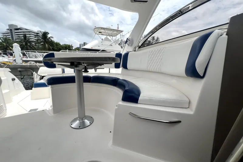 Slide: The Image of 2006 Regal Commodore 3560 IB yacht interior with white and blue seating, docked at marina. - 71