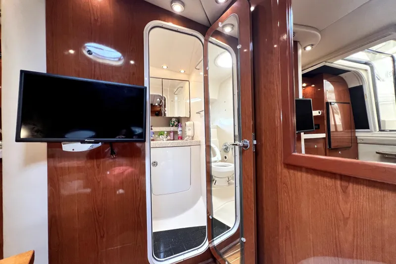 Slide: The Image of Interior of 2006 Regal Commodore 3560 IB yacht with TV and bathroom view. - 30