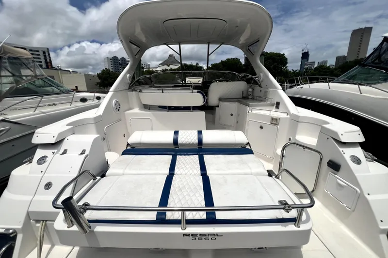 Slide: The Image of 2006 Regal Commodore 3560 IB yacht with spacious deck and seating, docked at marina. - 51