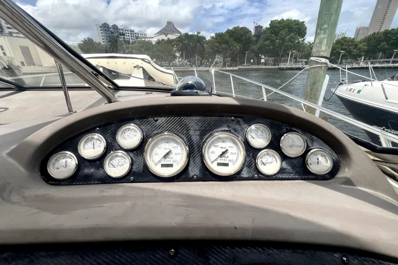 Slide: The Image of Dashboard of a 2006 Regal Commodore 3560 IB boat with gauges and waterfront view. - 14