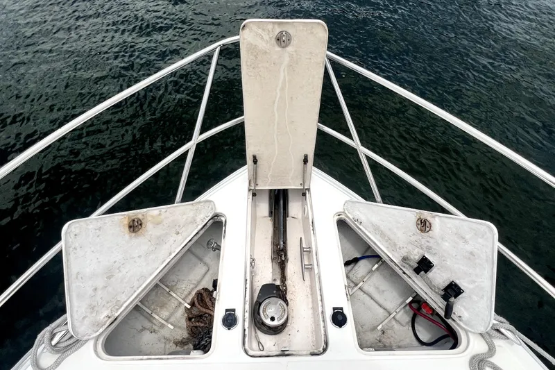 Slide: The Image of Bow view of a 2006 Regal Commodore 3560 IB boat with open storage compartments. - 22