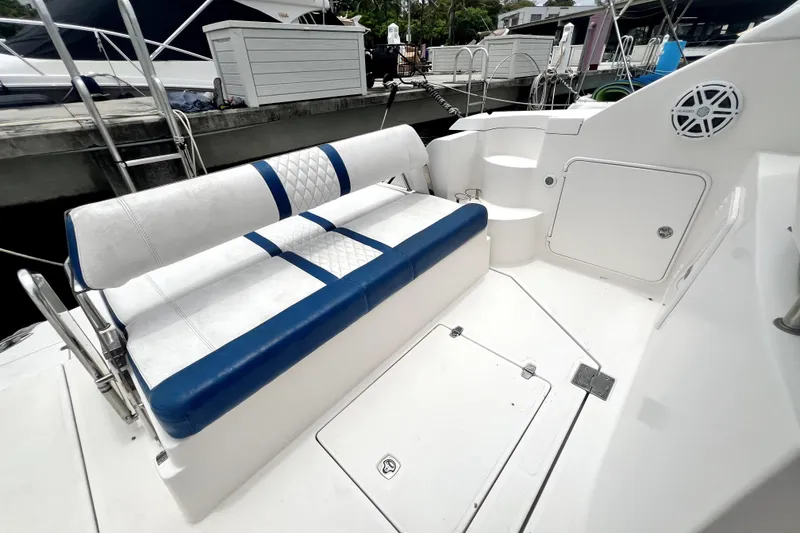 Slide: The Image of 2006 Regal Commodore 3560 IB boat seating area with blue and white upholstery. - 67