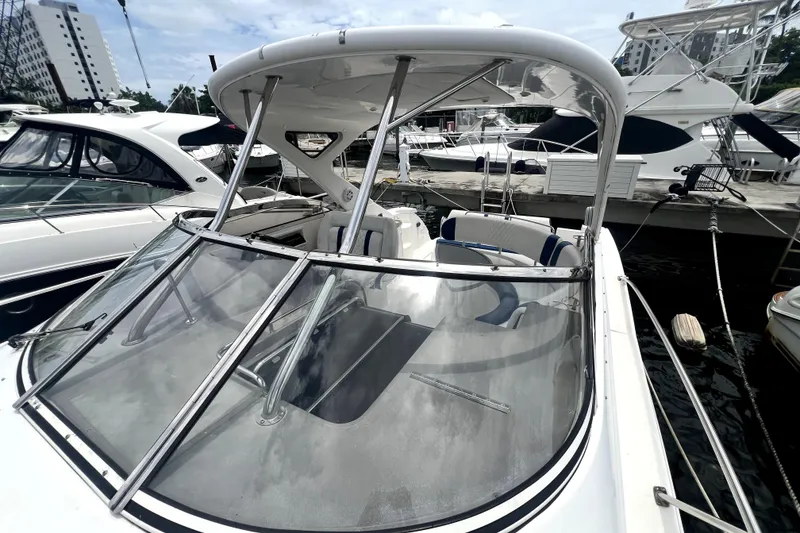 Slide: The Image of 2006 Regal Commodore 3560 IB yacht docked at marina, showcasing sleek design and spacious cockpit. - 56