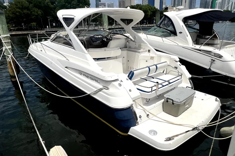 Slide: The Image of 2006 Regal Commodore 3560 IB yacht docked at marina, featuring sleek design and spacious deck. - 40