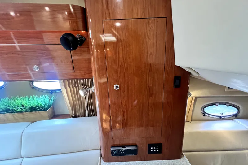 Slide: The Image of Interior of 2006 Regal Commodore 3560 IB yacht with wood paneling and porthole windows. - 76