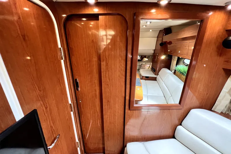 Slide: The Image of Luxurious interior of 2006 Regal Commodore 3560 IB yacht with wood paneling and white seating. - 82