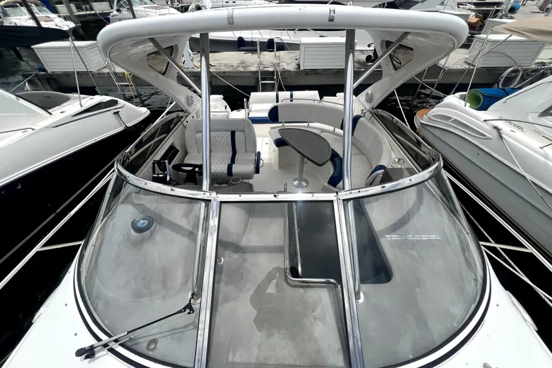 Slide: The Image of 2006 Regal Commodore 3560 IB boat with spacious seating and sleek design at a marina. - 20