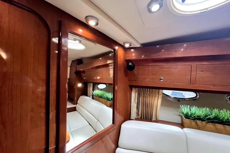 Slide: The Image of Luxurious interior of 2006 Regal Commodore 3560 IB yacht with wood finish and plush seating. - 83