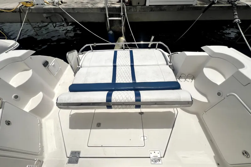 Slide: The Image of 2006 Regal Commodore 3560 IB boat with white and blue seating at dock. - 48