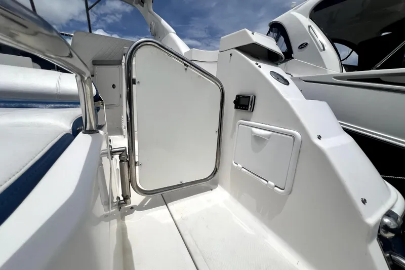 Slide: The Image of 2006 Regal Commodore 3560 IB yacht interior with white seating and open door. - 49