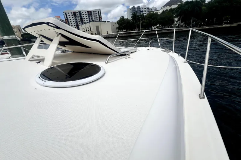 Slide: The Image of 2006 Regal Commodore 3560 IB yacht deck with cityscape background. - 54