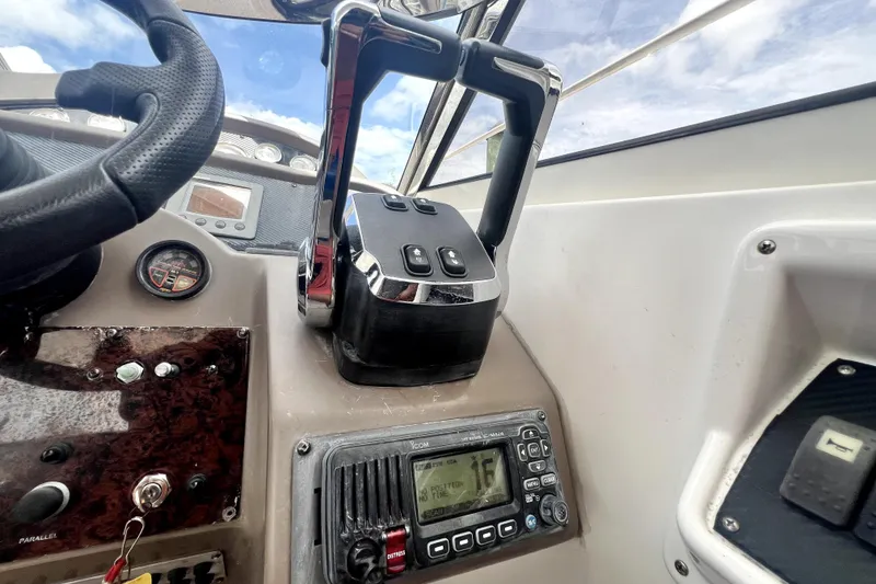 Slide: The Image of Control panel of a 2006 Regal Commodore 3560 IB boat with throttle and navigation instruments. - 44