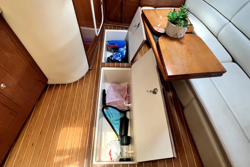 Slide: The Image of Interior of 2006 Regal Commodore 3560 IB with open storage compartments and wooden flooring. - 73