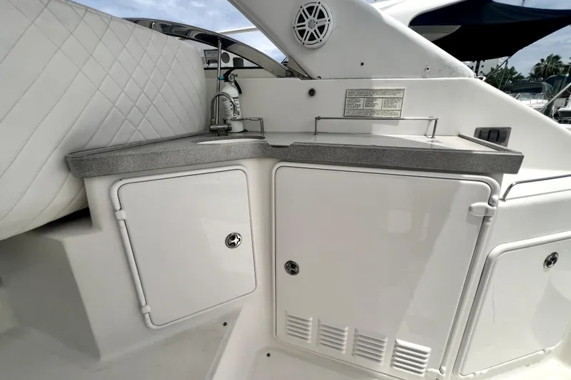 Slide: The Image of 2006 Regal Commodore 3560 IB yacht kitchenette with sink and storage cabinets. - 45
