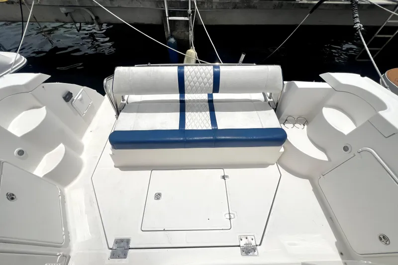 Slide: The Image of 2006 Regal Commodore 3560 IB boat seating area with blue and white upholstery. - 47