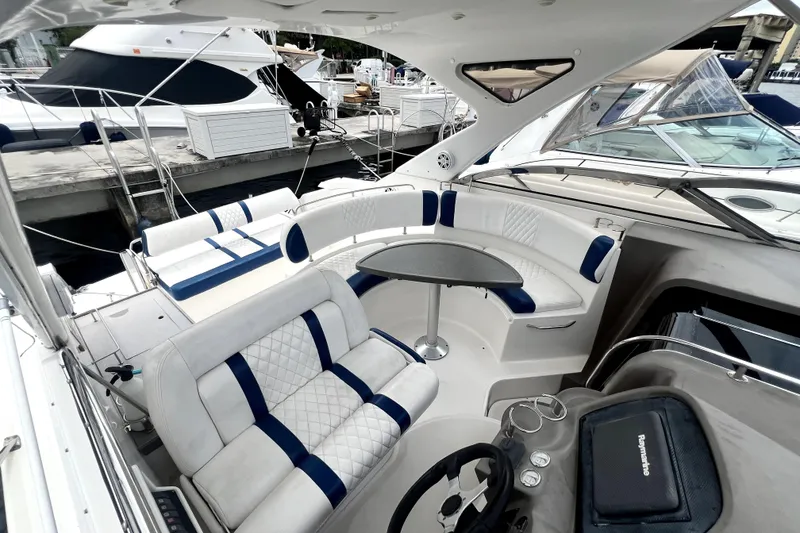 Slide: The Image of 2006 Regal Commodore 3560 IB yacht interior with white seating and table. - 52