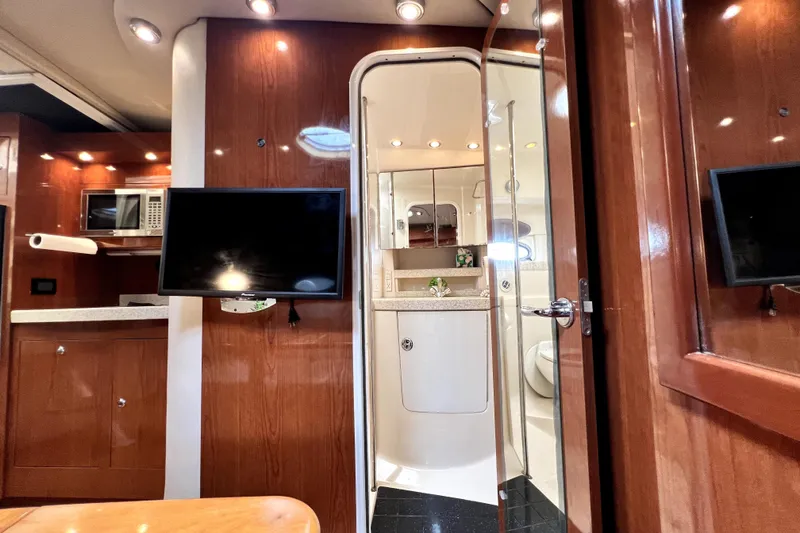 Slide: The Image of Interior of 2006 Regal Commodore 3560 IB yacht with wood paneling and modern amenities. - 28