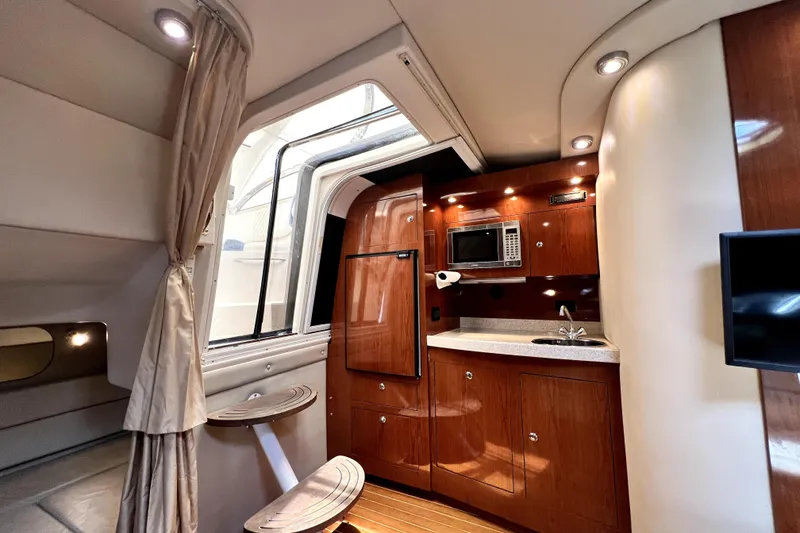 Slide: The Image of Luxurious interior of 2006 Regal Commodore 3560 IB yacht with kitchenette and seating area. - 34