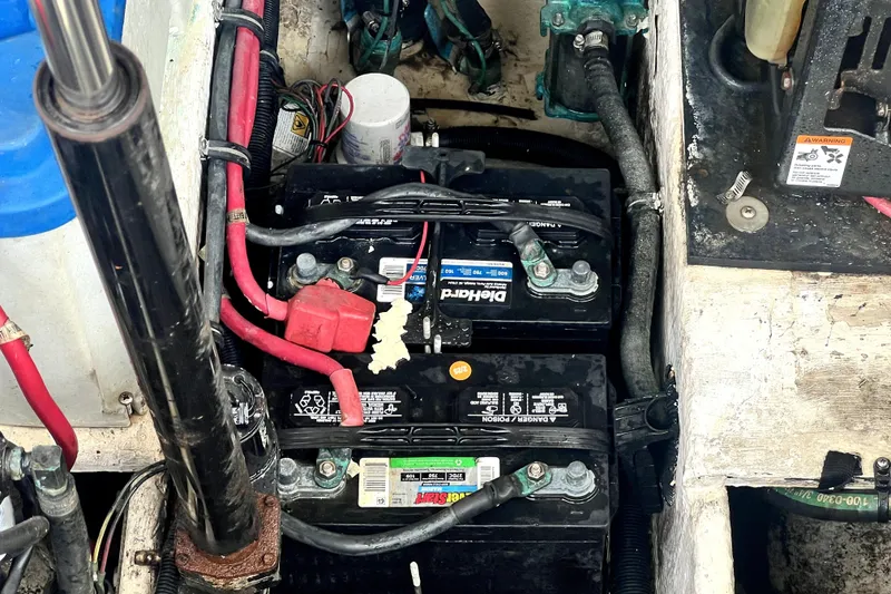 Slide: The Image of Battery compartment of a 2006 Regal Commodore 3560 IB boat, showing wiring and connections. - 24