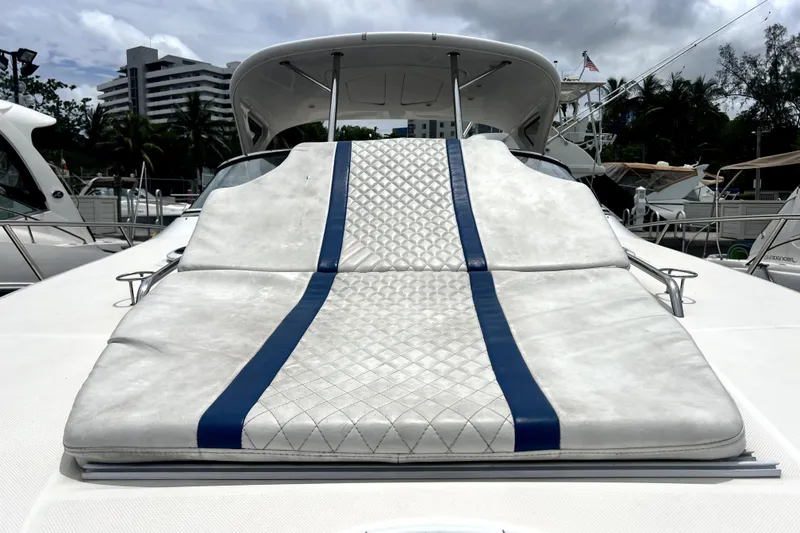 Slide: The Image of 2006 Regal Commodore 3560 IB yacht with cushioned sun deck, docked at marina. - 19