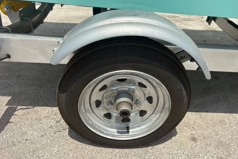 Slide: The Image of Trailer wheel of 2025 Exuma 14 Snookaholic, featuring a metal fender and tire on pavement. - 28