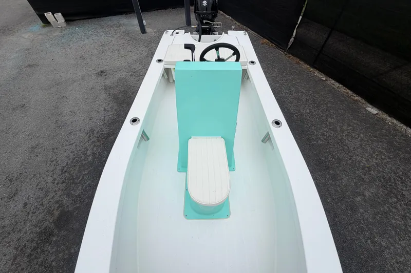 Slide: The Image of 2025 Exuma 14 Snookaholic boat interior with teal accents and steering wheel. - 31