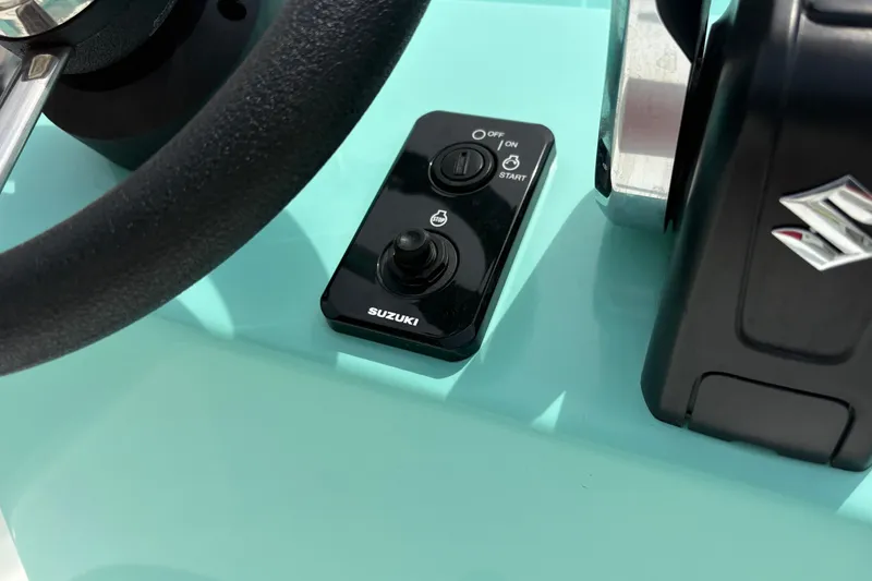 Slide: The Image of Steering wheel and Suzuki control panel on 2025 Exuma 14 Snookaholic boat. - 23