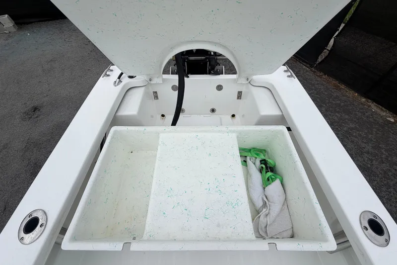 Slide: The Image of Open storage compartment in Exuma 14 Snookaholic boat, with towel and rope. - 45