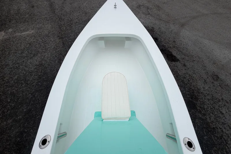 Slide: The Image of 2025 Exuma 14 Snookaholic boat interior with white and teal design. - 26