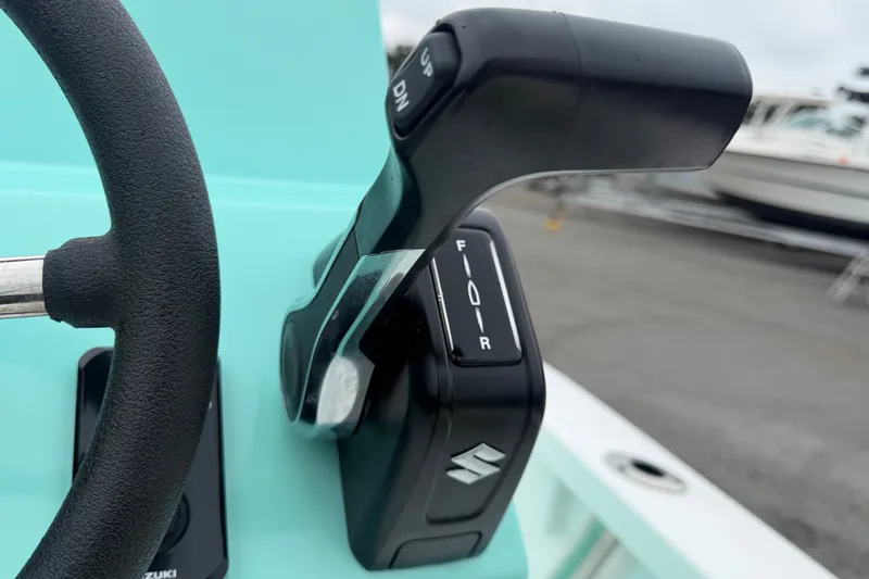 Slide: The Image of Close-up of Exuma 14 Snookaholic 2025 boat throttle and steering wheel. - 19